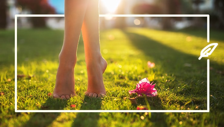 woman feet on the grass