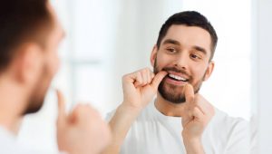 man cleaning his teeth