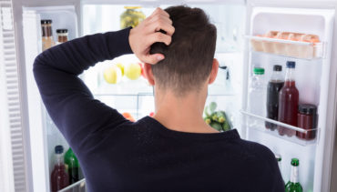 man opens the fridge