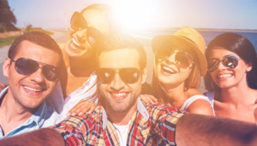 young people with sunglasses taking selfie