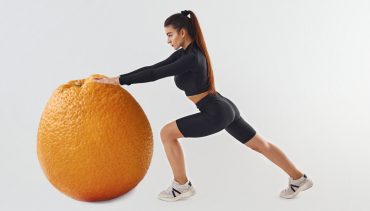 woman pushing an orange