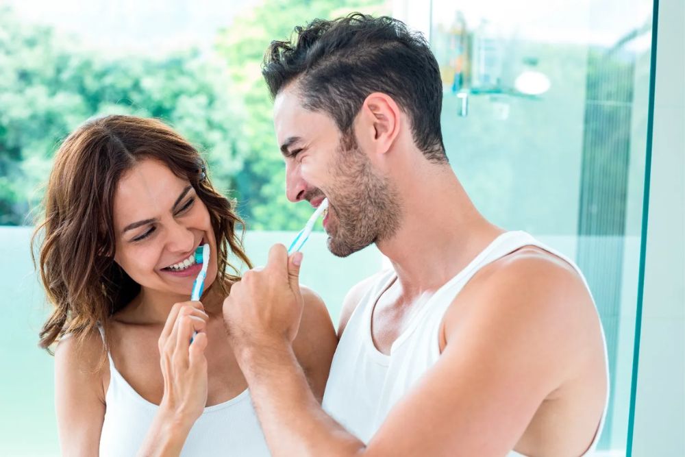 couple brushes their teeth