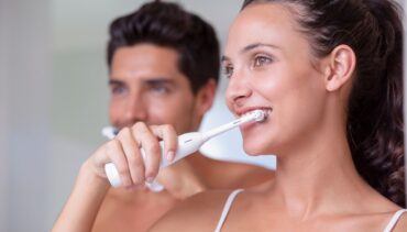 couple brushing teeth