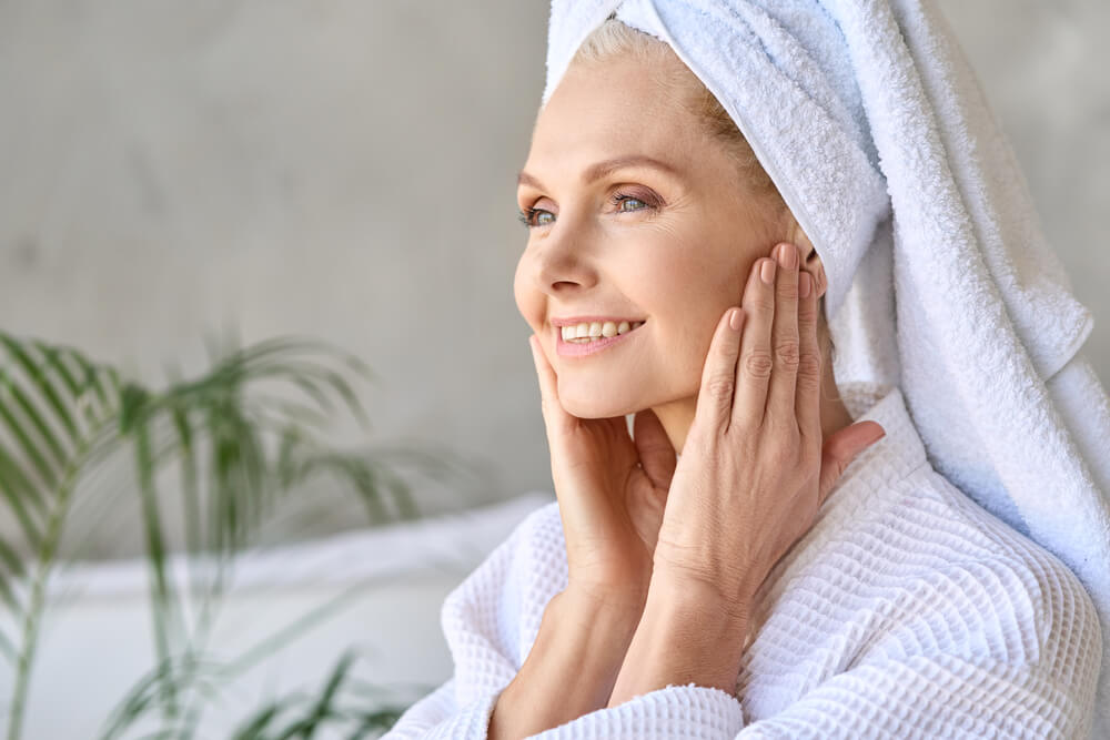 old woman with towels smiles