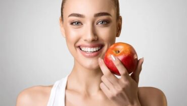 smiling woman with apple in her hands