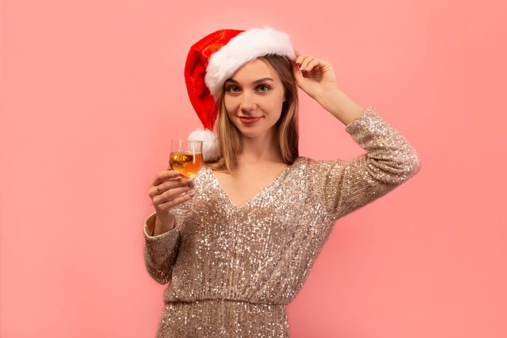 woman with santa clauss drinking wine