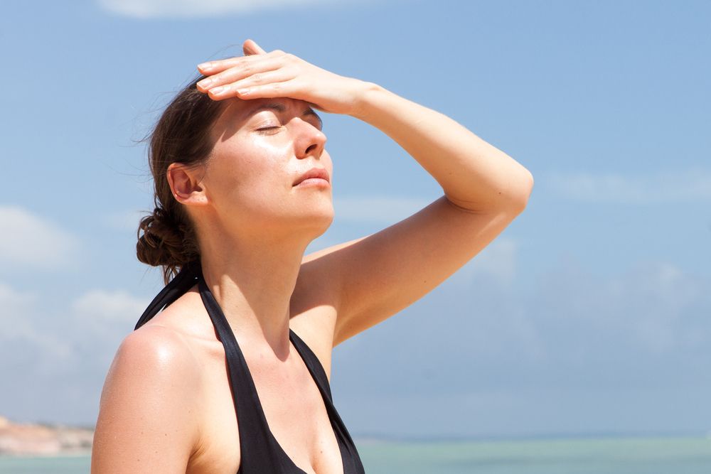 woman with headache from the sun