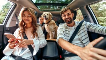 family with dog in the car