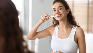 woman brushes her teeth