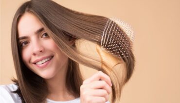 woman brushes her hair