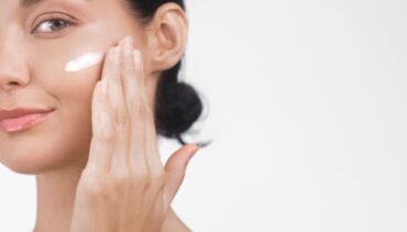 woman applies moisturizing cream in her face