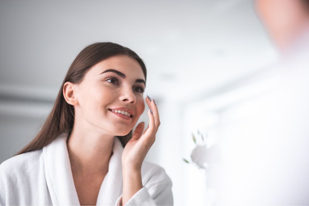 Woman applying serum on her face