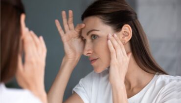 Woman watches her face