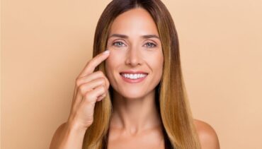 woman touches her eyes
