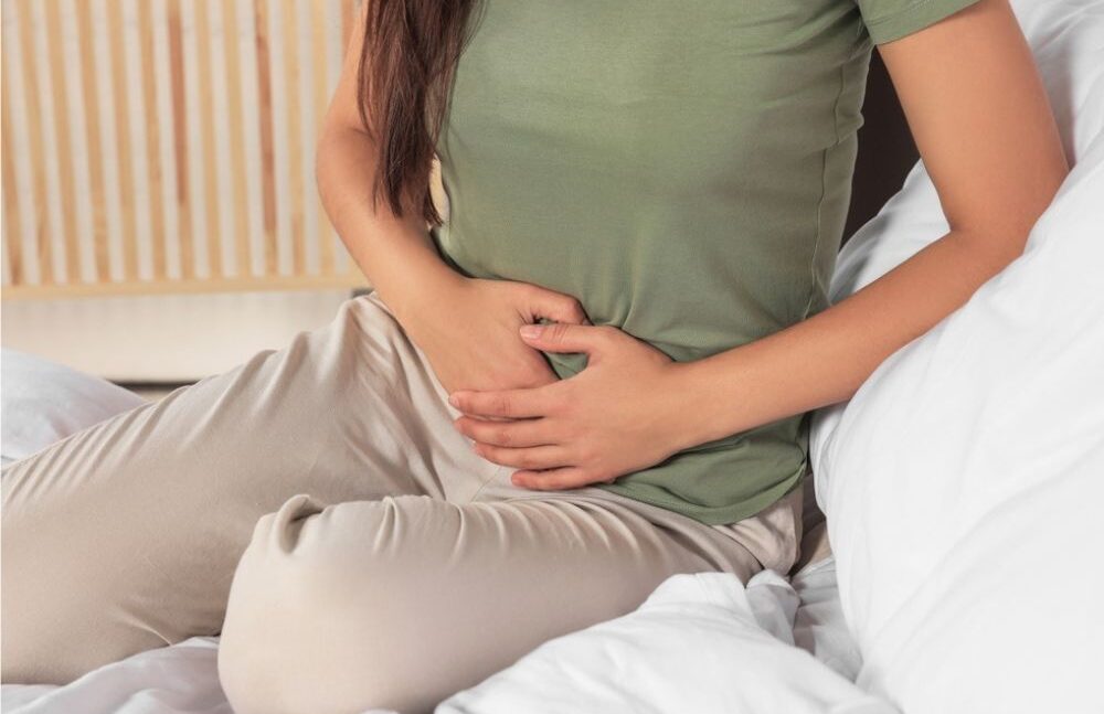 WOMAN TOUCHING HER BELLY