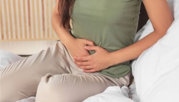 WOMAN TOUCHING HER BELLY
