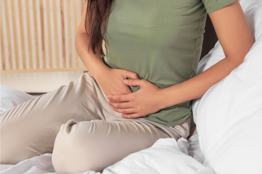 WOMAN TOUCHING HER BELLY