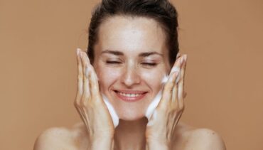 WOMAN CLEANING HER FACE