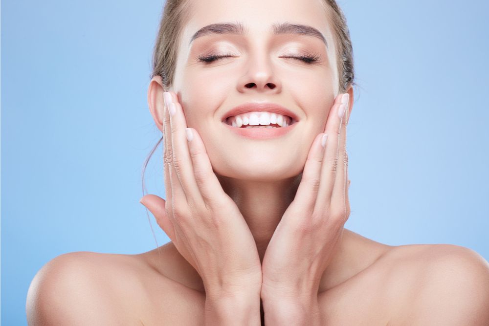 beautiful woman touching her face
