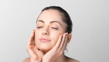 woman applying cream on her face