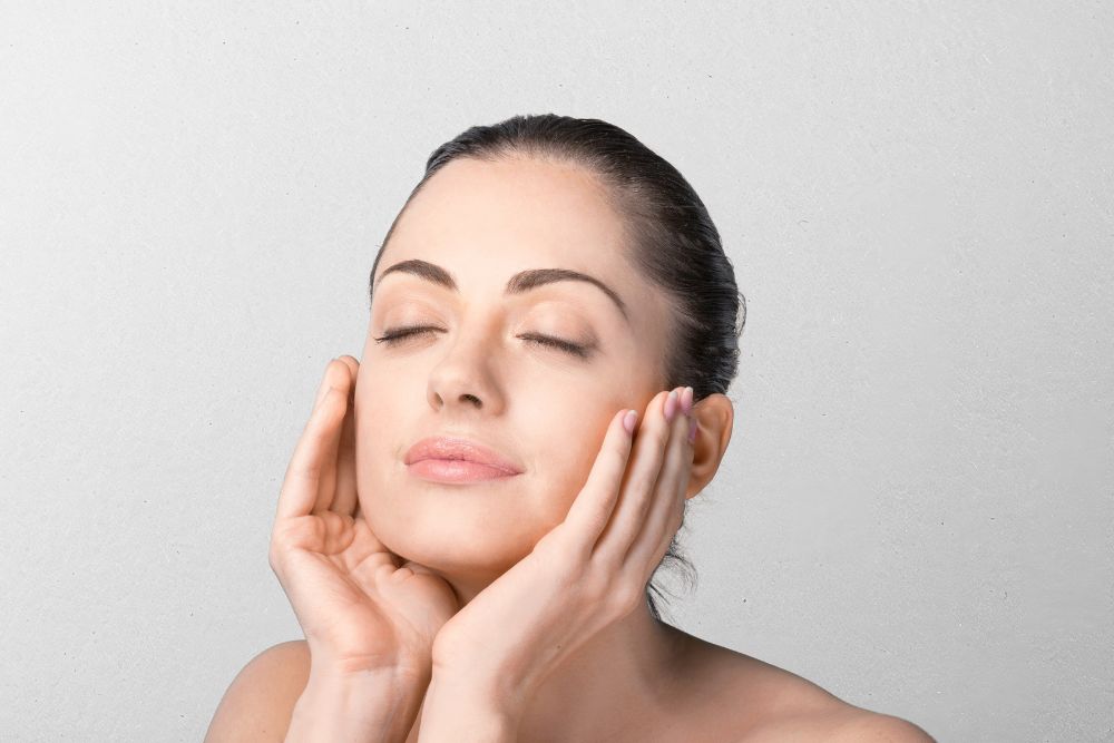 woman applying cream on her face