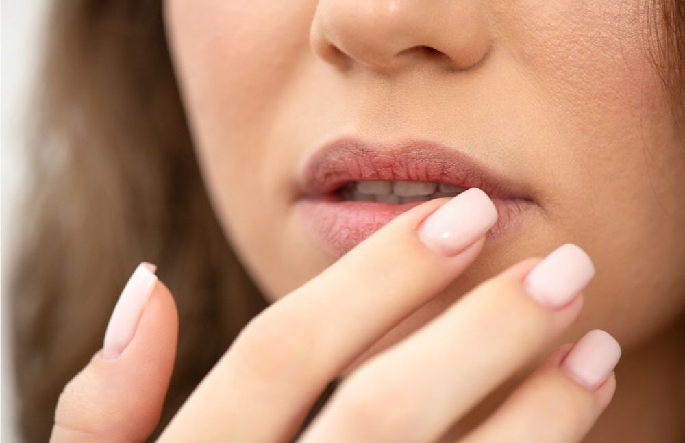 woman toucing her lips