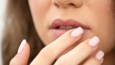 woman toucing her lips